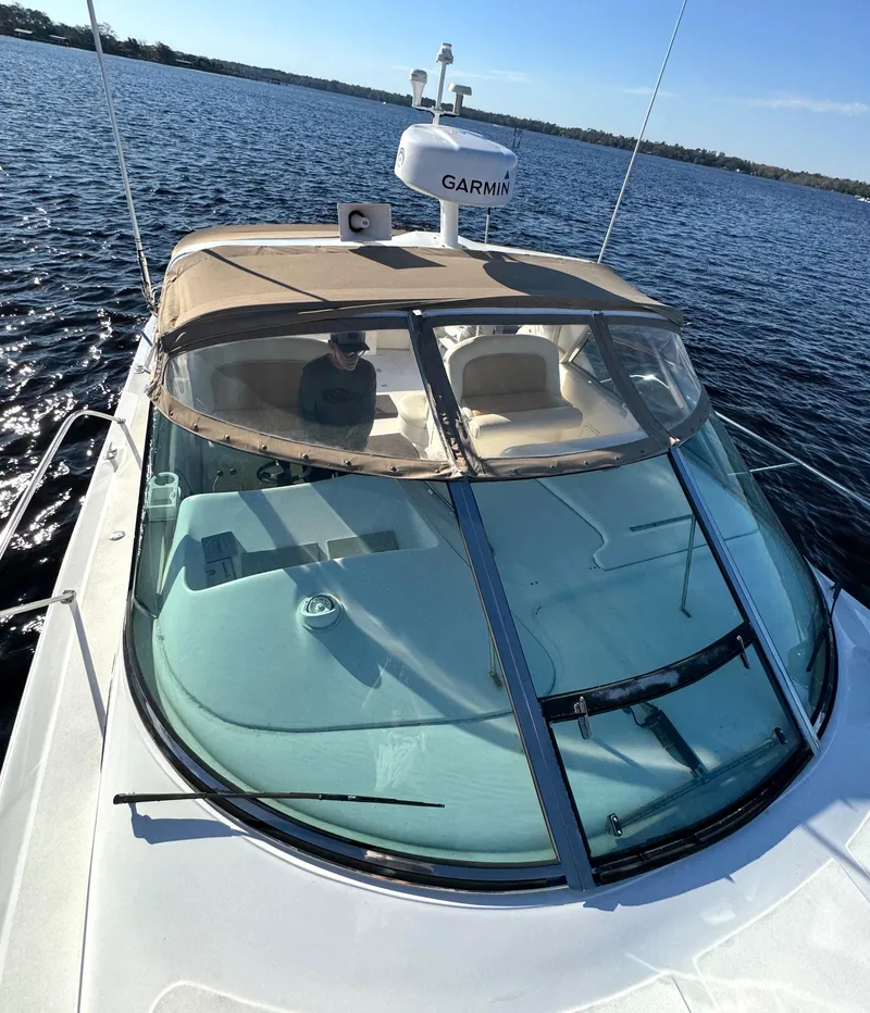 Slide: The Image of 1997 Sea Ray 370 Express Cruiser on calm water, featuring Garmin equipment. - 46