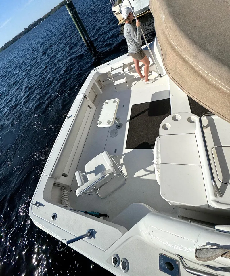 Slide: The Image of 1997 Sea Ray 370 Express Cruiser with spacious deck, docked by the water. - 48