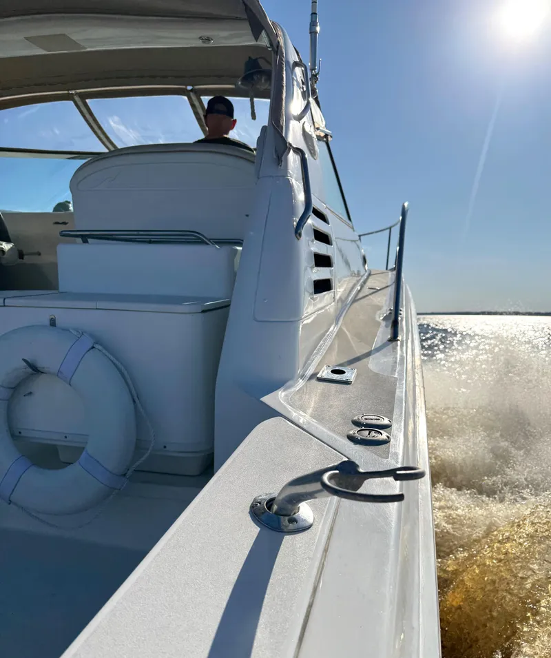 Slide: The Image of 1997 Sea Ray 370 Express Cruiser on water, labeled "Off The Edge," Orange Park, FL. - 5