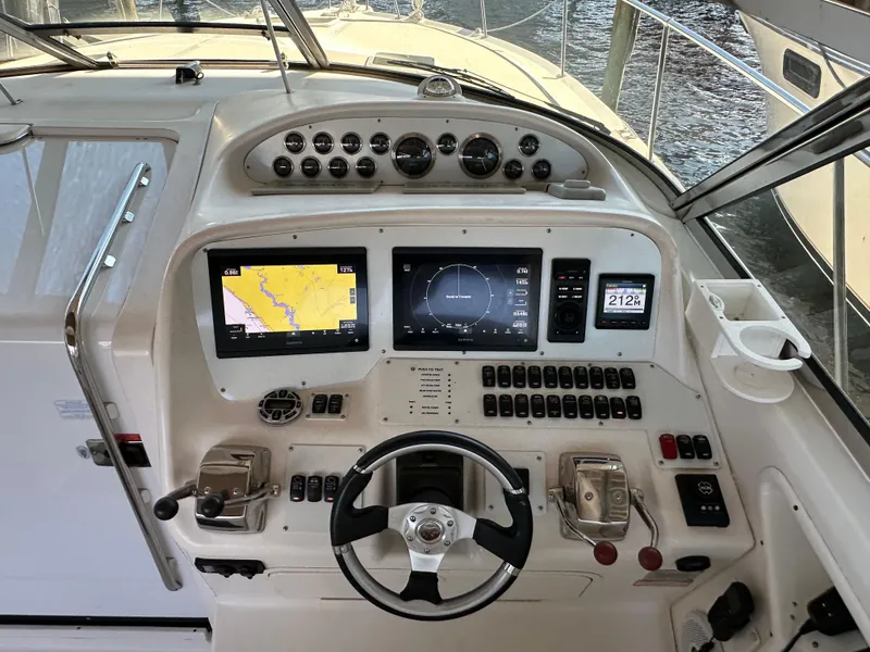 Slide: The Image of 1997 Sea Ray 370 Express Cruiser navigating on sunny waters. - 8