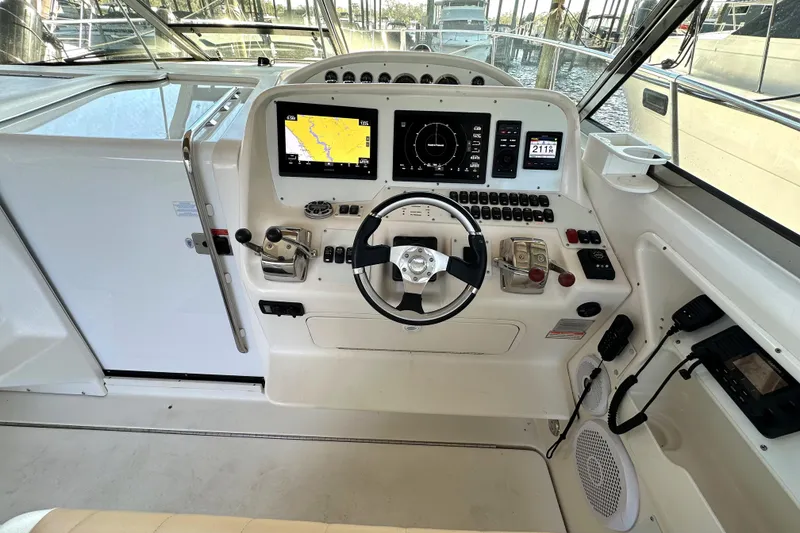 Slide: The Image of 1997 Sea Ray 370 Express Cruiser interior with seating, cruising on open water. - 9
