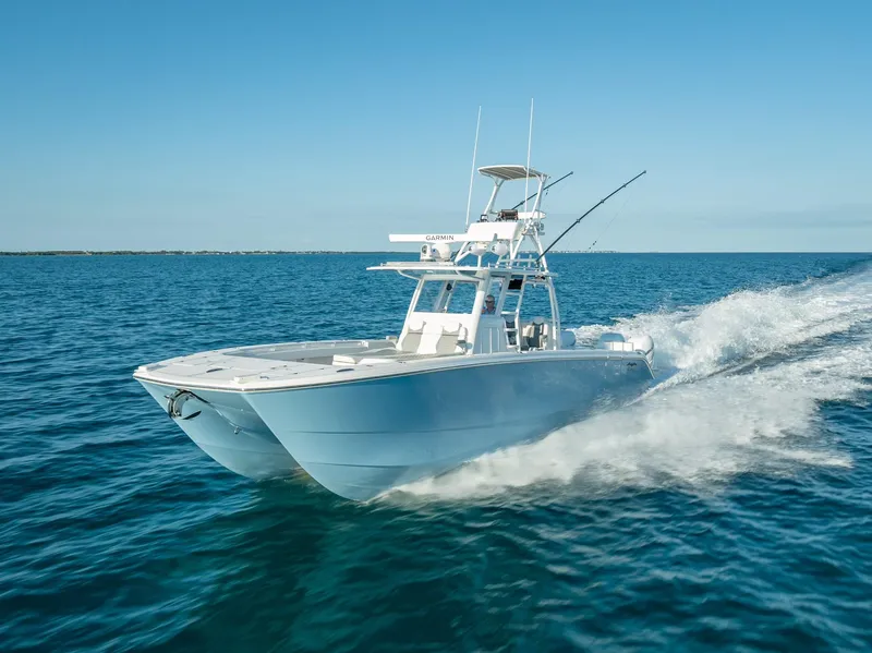 Slide: The Image of 2023 Invincible 37 Catamaran cruising on open blue water. - 10