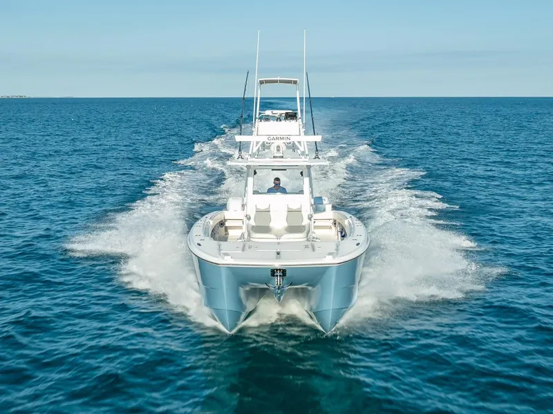 Slide: The Image of 2023 Invincible 37 Catamaran cruising on open ocean waters. - 11