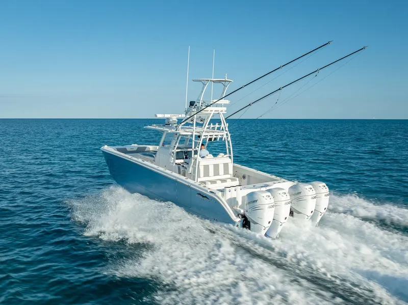 Slide: The Image of 2023 Invincible 37 Catamaran cruising on open sea with triple outboard engines. - 15