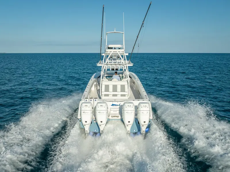 Slide: The Image of 2023 Invincible 37 Catamaran cruising on open water, showcasing powerful engines. - 16