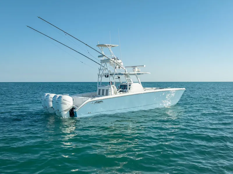 Slide: The Image of 2023 Invincible 37 Catamaran on open sea, showcasing sleek design and powerful engines. - 2