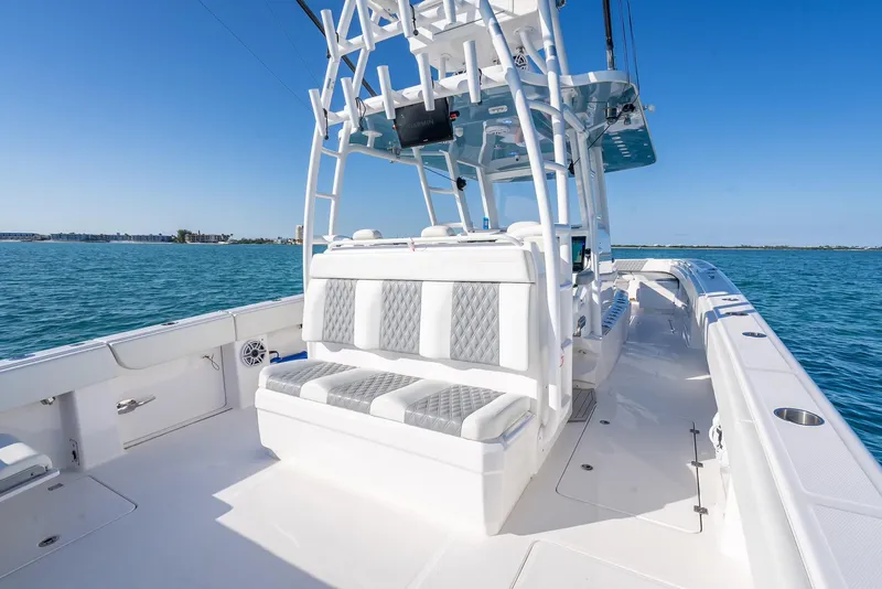 Slide: The Image of 2023 Invincible 37 Catamaran on open water, showcasing spacious deck and seating. - 35