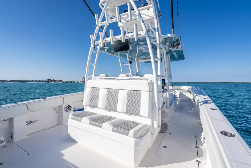 Slide: The Image of 2023 Invincible 37 Catamaran with spacious seating, sleek design, and ocean backdrop. - 36