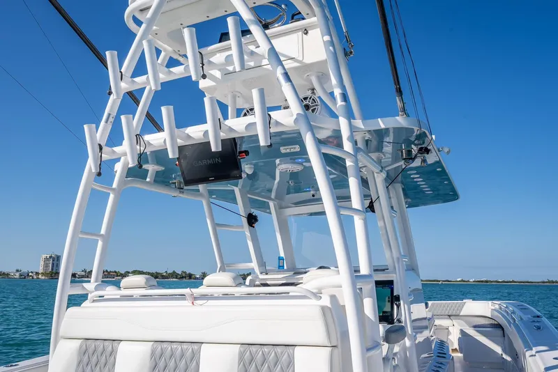 Slide: The Image of 2023 Invincible 37 Catamaran with sleek design, advanced features, and ocean backdrop. - 37