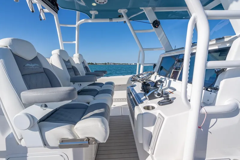 Slide: The Image of 2023 Invincible 37 Catamaran interior with modern seating and navigation controls. - 46