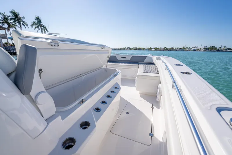 Slide: The Image of 2023 Invincible 37 Catamaran interior with open storage, ocean view, and palm trees. - 49