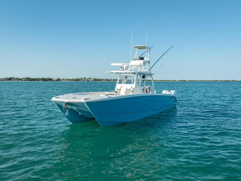 Slide: The Image of 2023 Invincible 37 Catamaran on clear blue water, showcasing sleek design and advanced features. - 5