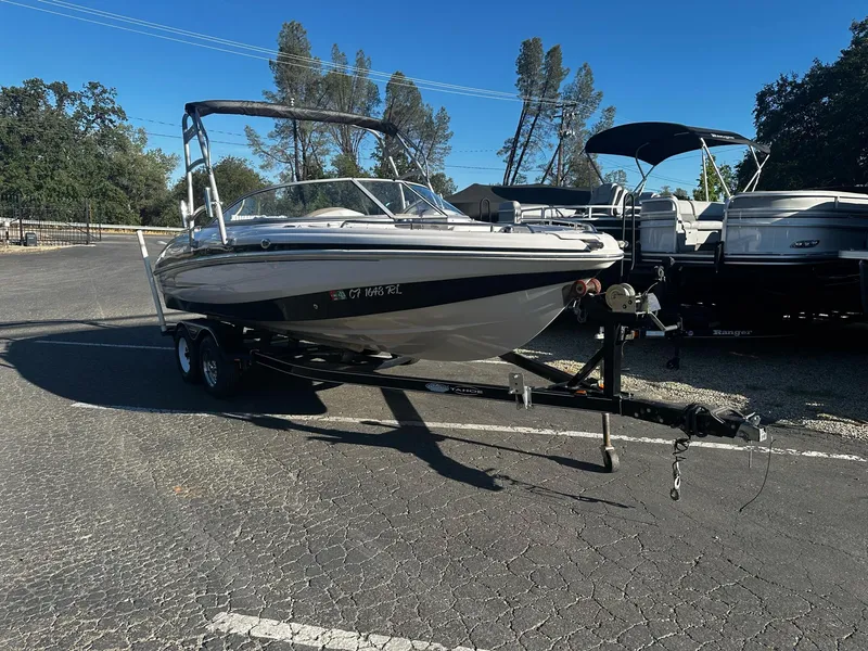 Slide: The Image of 2006 Tahoe 215 I/O boat on trailer in parking lot, sunny day. - 3