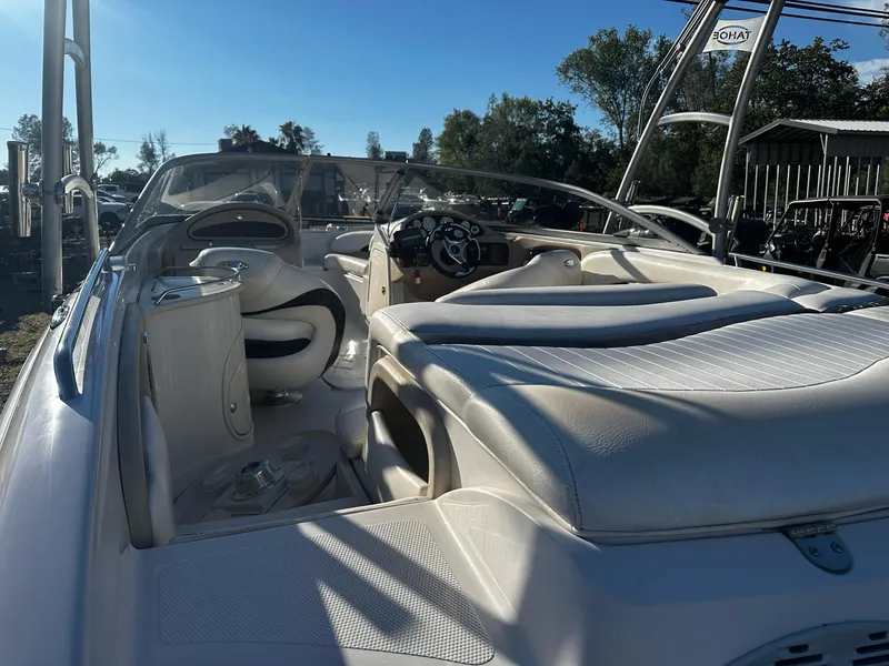 Slide: The Image of 2006 Tahoe 215 I/O boat interior with white seating and steering console. - 5