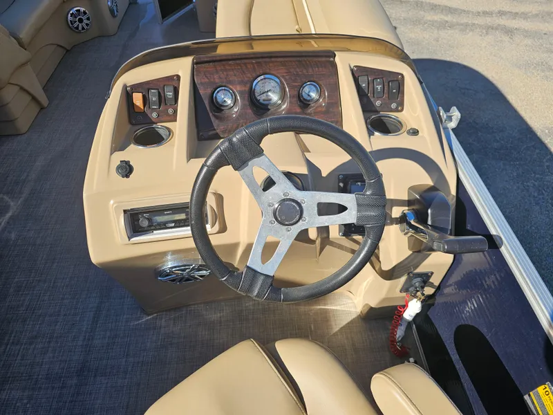 Slide: The Image of Steering console of a 2016 Bennington 22SLX boat with gauges and controls. - 5