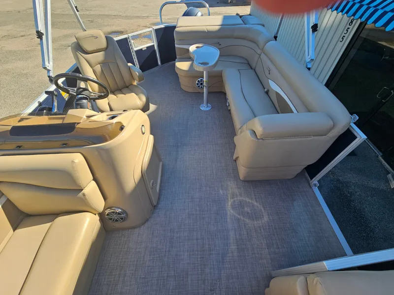 Slide: The Image of 2016 Bennington 22SLX pontoon boat interior with beige seating and steering console. - 6