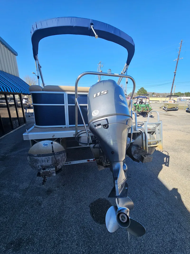 Slide: The Image of 2016 Bennington 22SLX pontoon boat with outboard motor, parked outdoors. - 7