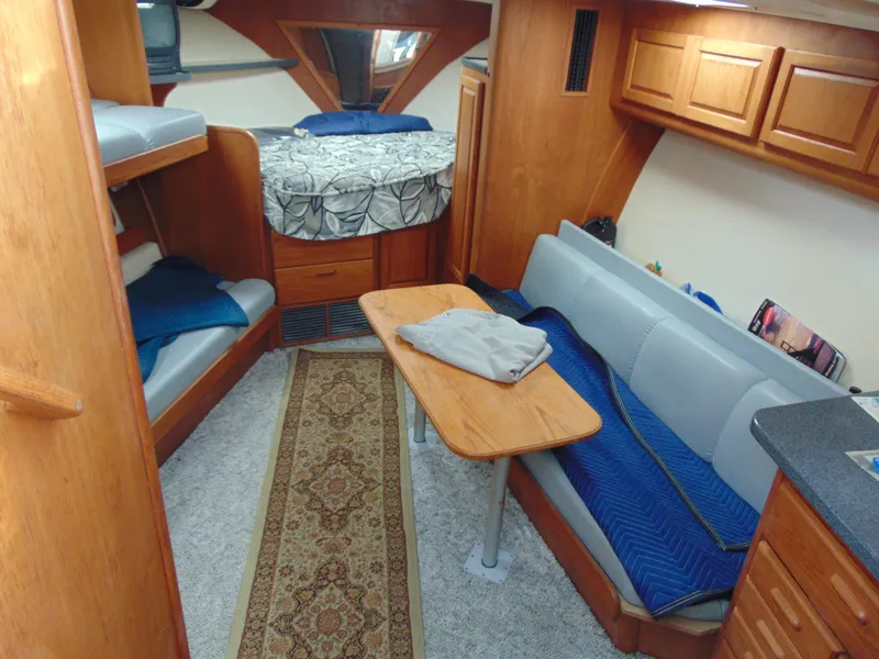 Slide: The Image of Interior of 2000 Luhrs T-360SX/SF boat with cozy seating and wooden cabinetry. - 10