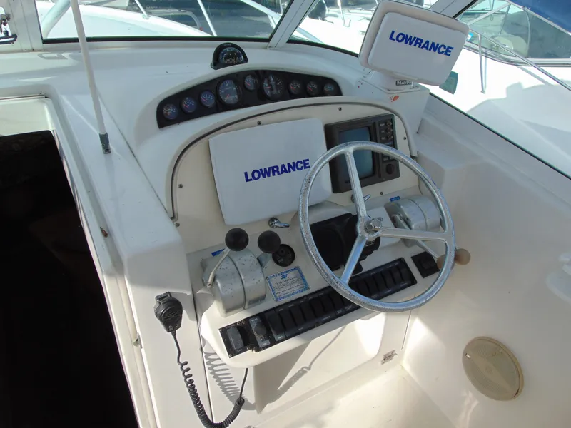 Slide: The Image of 2000 Luhrs T-360SX/SF boat helm with Lowrance navigation equipment and steering wheel. - 11