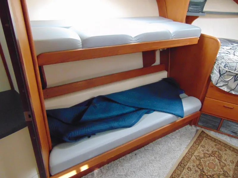 Slide: The Image of Bunk beds in 2000 Luhrs T-360SX/SF boat cabin with blue blanket. - 12