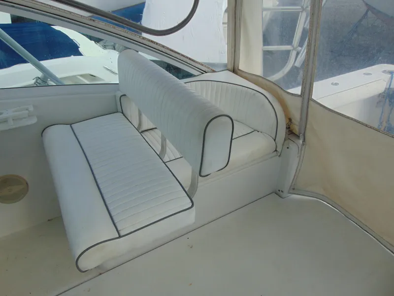 Slide: The Image of 2000 Luhrs T-360SX/SF boat interior with white cushioned seating. - 15