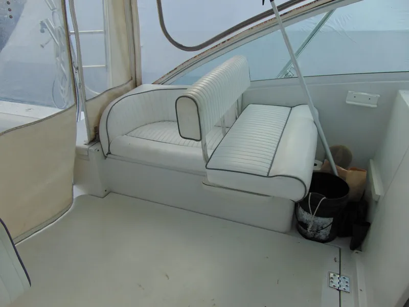 Slide: The Image of 2000 Luhrs T-360SX/SF boat interior with white seating and storage area. - 16