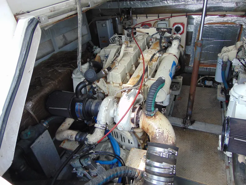 Slide: The Image of Engine room of a 2000 Luhrs T-360SX/SF boat, showcasing dual engines and mechanical components. - 18