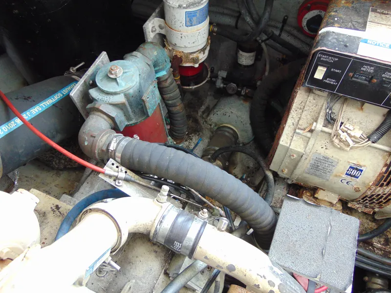 Slide: The Image of Engine compartment of a 2000 Luhrs T-360SX/SF boat, showing mechanical components and hoses. - 26