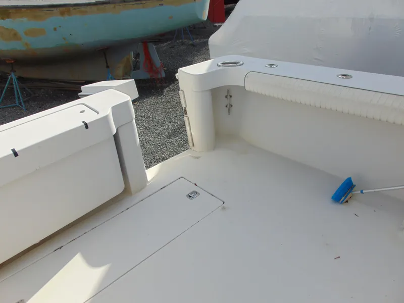 Slide: The Image of 2000 Luhrs T-360SX/SF boat deck with storage compartments and cleaning brush. - 7