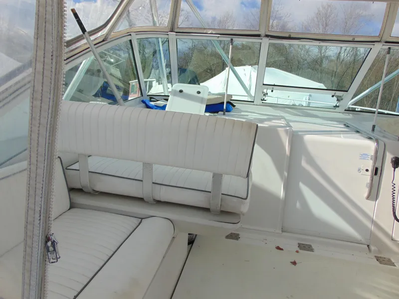 Slide: The Image of 2000 Luhrs T-360SX/SF boat interior with white seating and clear windows. - 8