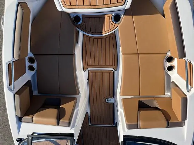 Slide: The Image of 2024 Yamaha Boats 222S interior with tan seating and wood accents. - 5