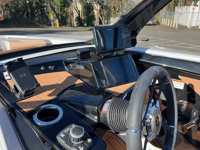 Slide: The Image of 2024 Yamaha Boats 222S dashboard with steering wheel and navigation system. - 7