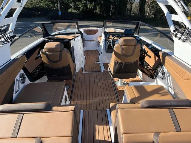 Slide: The Image of 2024 Yamaha Boats 222S interior with brown seating and sleek design. - 9