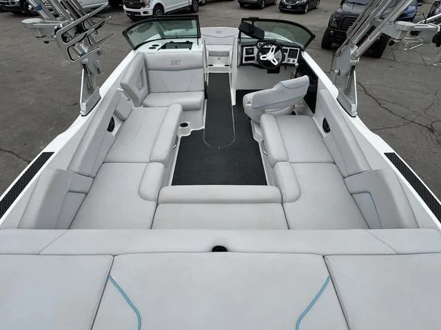 Slide: The Image of 2019 MasterCraft NXT22 boat interior with white cushioned seating and open bow design. - 14