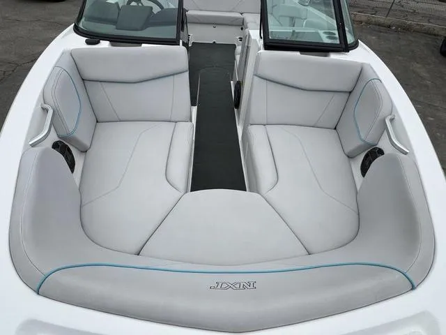 Slide: The Image of 2019 MasterCraft NXT22 boat interior with white seating and cup holders. - 15