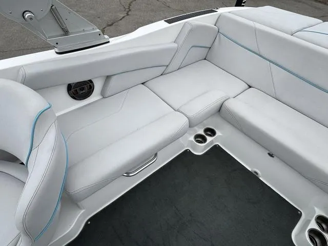 Slide: The Image of 2019 MasterCraft NXT22 boat interior with white seating and cup holders. - 16
