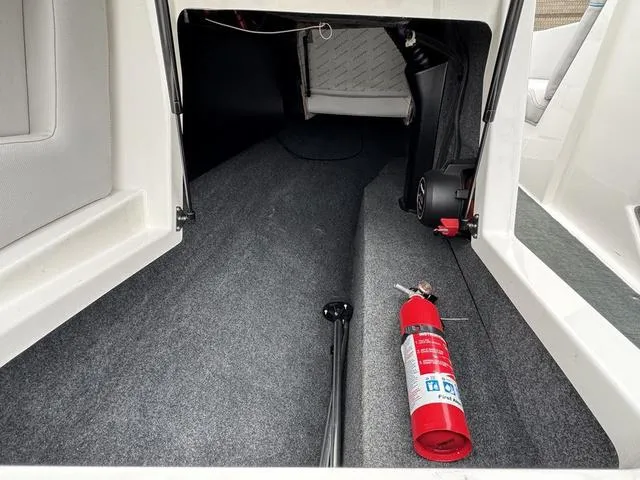 Slide: The Image of Storage compartment in a 2019 MasterCraft NXT22 boat, featuring a sleek interior design. - 23