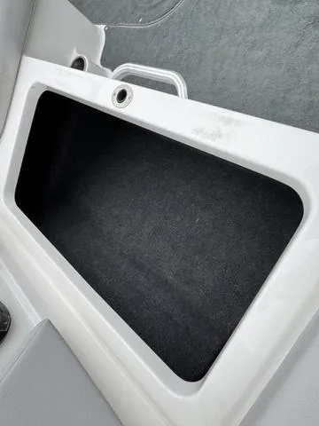 Slide: The Image of 2019 MasterCraft NXT22 boat engine compartment with Ilmor engine, open storage areas. - 24