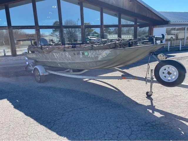 Slide: The Image of 2003 Lowe Roughneck boat on trailer outside a building, sunny day. - 1