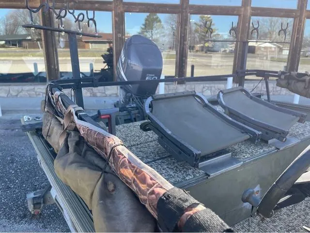 Slide: The Image of 2003 Lowe Roughneck boat with motor and fishing rod holders. - 10