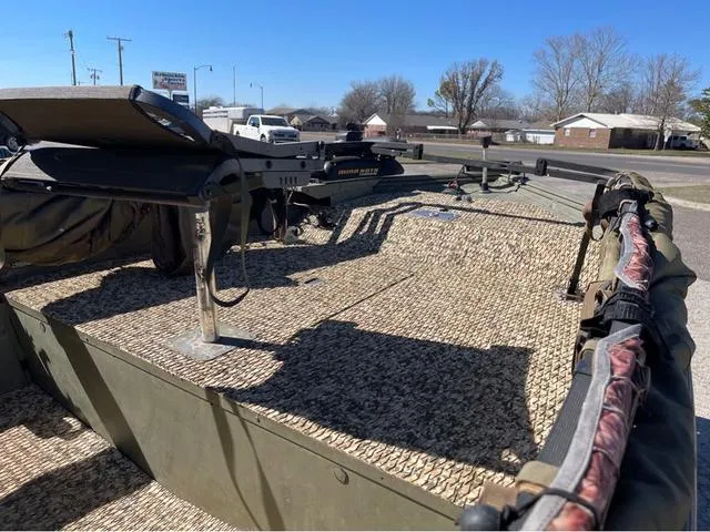 Slide: The Image of 2003 Lowe Roughneck boat with camo deck, parked outdoors. - 11