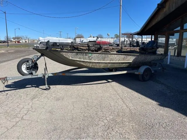 Slide: The Image of 2003 Lowe Roughneck boat on trailer, parked outdoors on a sunny day. - 2
