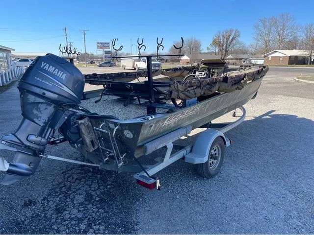 Slide: The Image of 2003 Lowe Roughneck boat with Yamaha motor on trailer, parked outdoors. - 3