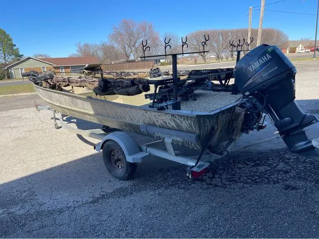 Slide: The Image of 2003 Lowe Roughneck boat with Yamaha motor on trailer, parked outdoors. - 4