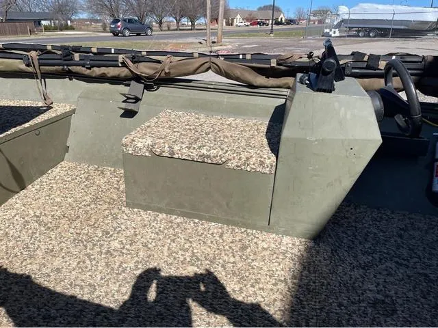 Slide: The Image of 2003 Lowe Roughneck boat interior with camouflage seating and steering console. - 8