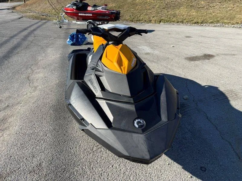 Slide: The Image of 2018 Sea-Doo Spark 3up jet ski, yellow and black, parked on pavement. - 10
