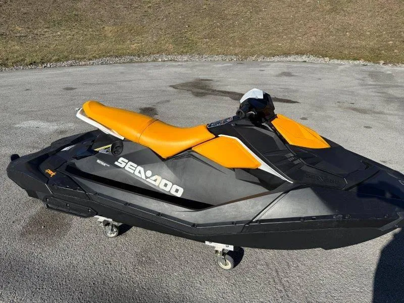 Slide: The Image of 2018 Sea-Doo Spark 3up jet ski with orange seat on pavement. - 19