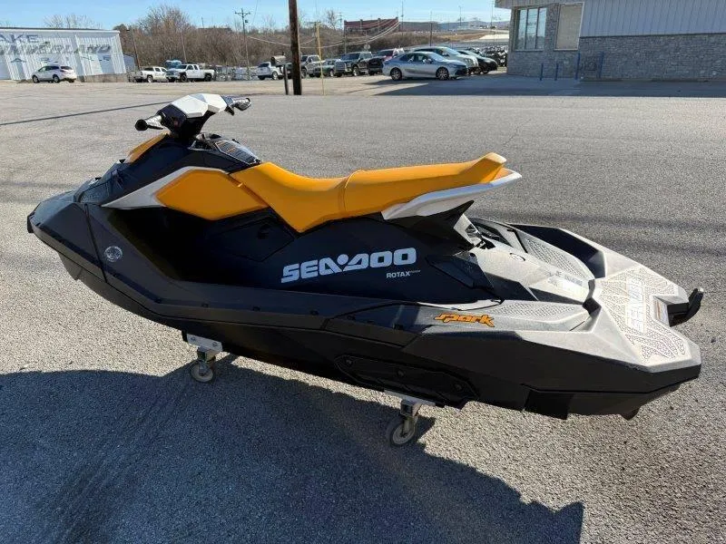 Slide: The Image of 2018 Sea-Doo Spark 3up jet ski with yellow seat, parked on pavement. - 20