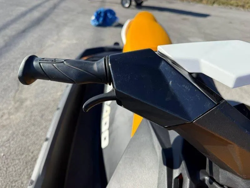 Slide: The Image of Close-up of 2018 Sea-Doo Spark 3up handlebar and throttle on pavement. - 32