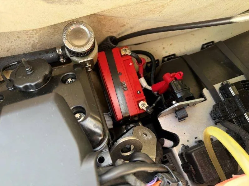 Slide: The Image of Engine compartment of a 2022 Sea-Doo RXP-X 300, featuring battery and components. - 26